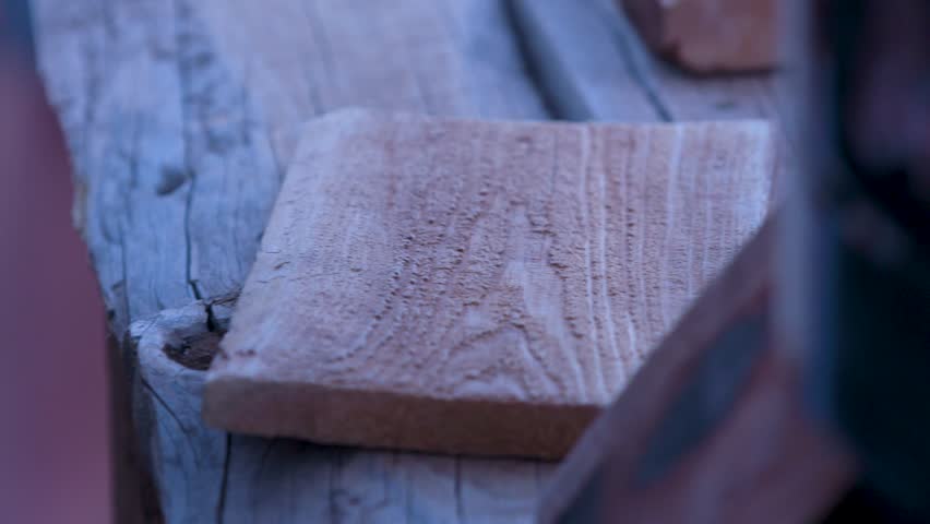 Branding iron creating logos in wood. Fire branding wood planks
