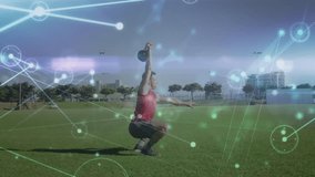 Trainer driving heels and swinging kettlebell from low squat on grass field for strength training. Fitness, strength, athleticism, outdoor, training, dynamic, endurance - Powered by Shutterstock - Get 15% off with code: PIKWIZARD15