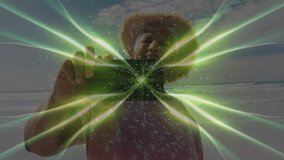 Senior woman holding smartphone at shore and activating green fractal waves filter for social media. Digital art, creativity, serenity, outdoor, vibrant, technology, mindfulness - Powered by Shutterstock - Get 15% off with code: PIKWIZARD15