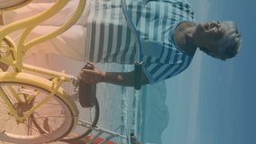 Spots of light against african american senior couple with bicycles walking together at the beach. pedal day awareness concept - Powered by Shutterstock - Get 15% off with code: PIKWIZARD15