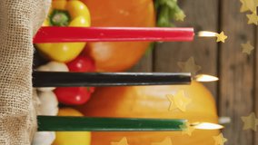 Animation of golden stars over kwanzaa candles and pumpkins. Kwanzaa festivity, celebration and tradition concept digitally generated video. - Powered by Shutterstock - Get 15% off with code: PIKWIZARD15