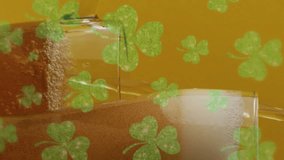 Animation of st patrick's day green shamrock falling over beer glasses. St patrick's day, irish tradition and celebration concept digitally generated video - Powered by Shutterstock - Get 15% off with code: PIKWIZARD15
