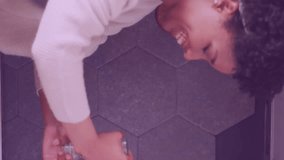 Animation of flowers over happy diverse couple cooking together. Relationship, love, romance and lifestyle concept digitally generated video. - Powered by Shutterstock - Get 15% off with code: PIKWIZARD15