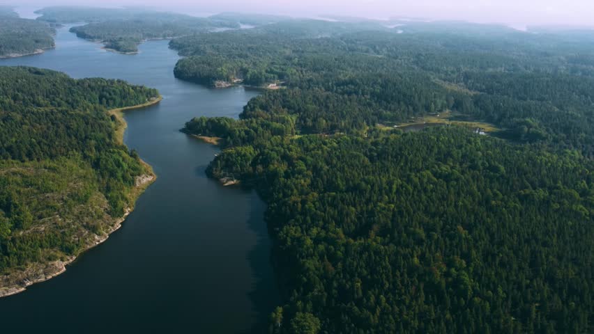 Russia, Lake Ladoga, Koyonsaari. View of the coast of the island in a cold lake. Beautiful nature of the Republic of Karelia. Panoramic view from the height of the Ladoga skerry islands. 4K
