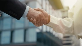 Closeup diversity man and woman shaking hands in city business agreement handshaking multiracial male female businessman with businesswoman partnership gesture successful deal teamwork cooperation - Powered by Shutterstock - Get 15% off with code: PIKWIZARD15