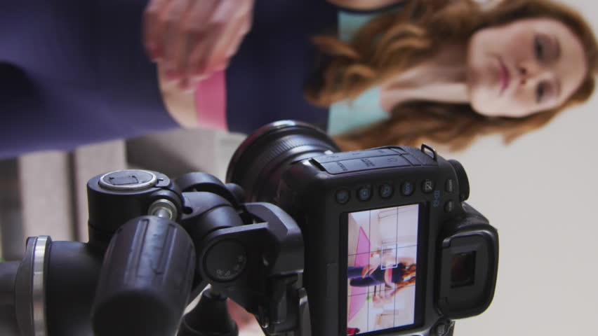 Animation of data processing over caucasian woman exercising, recording fitness vlog. Global online vlogging, fitness, digital interface and connections concept digitally generated video.