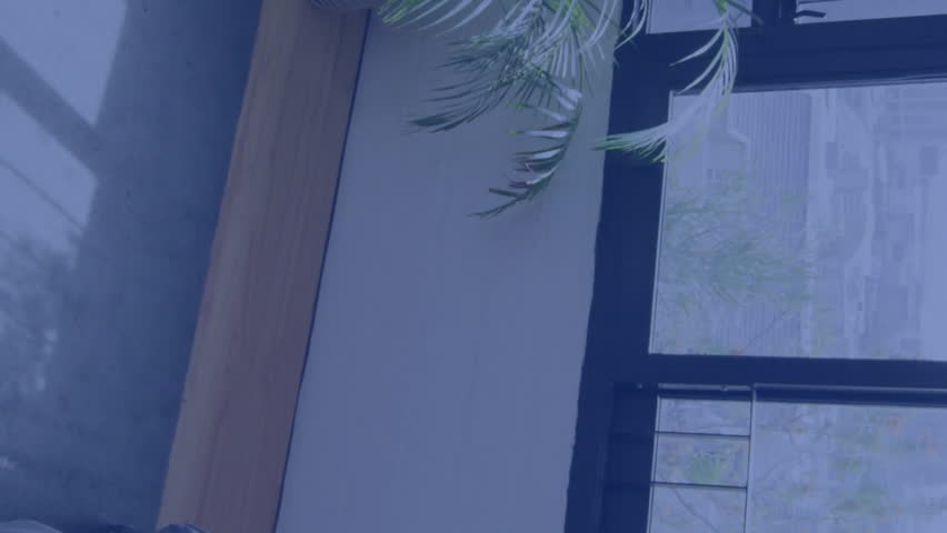 Facial recognition animation over bedroom with large windows and indoor plant. Technology, innovation, security, digital, AI, home