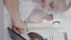 Animation of trading board over caucasian students using digital tablet in classroom. Digital composite, multiple exposure, stock market, investment, e-learning, childhood, education and technology. - Powered by Shutterstock - Get 15% off with code: PIKWIZARD15