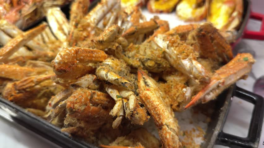 Big shrimps fry on a frying pan.