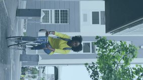 Animation of media icons over african american woman riding bicycle in city. Social media and digital interface concept digitally generated video. - Powered by Shutterstock - Get 15% off with code: PIKWIZARD15