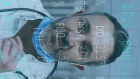 Animation of stock market data processing over caucasian male doctor wearing face mask at hospital. Global economy and medical healthcare technology concept - Powered by Shutterstock - Get 15% off with code: PIKWIZARD15