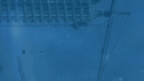 Animation of ticking clock icon and data processing against aerial view of construction site. Computer interface and business technology concept - Powered by Shutterstock - Get 15% off with code: PIKWIZARD15