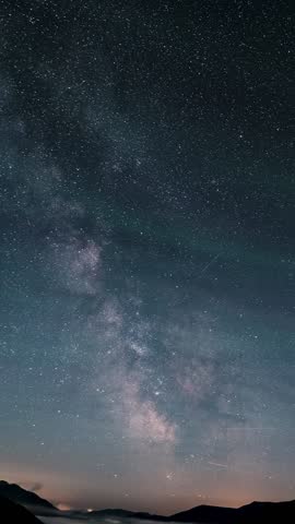 Milky Way Galaxy Over Mountains, Starry Night to Day Vertical Time Lapse