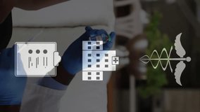 Animation of medical icons over african american male doctor and patient discussing vaccine. Medical services, coronavirus, protection, digital interface and communication, digitally generated video. - Powered by Shutterstock - Get 15% off with code: PIKWIZARD15