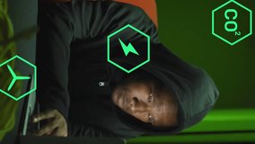 Using laptop with animation of green energy icons, person in hoodie working. Technology, innovation, sustainable, environment, renewable, eco-friendly - Powered by Shutterstock - Get 15% off with code: PIKWIZARD15
