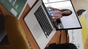 Animation of binary coding over african american woman having a video call on laptop at home. Global networking and business technology concept - Powered by Shutterstock - Get 15% off with code: PIKWIZARD15