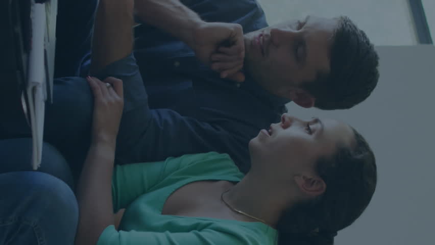 A young couple is talking and paying their bills using a laptop. They are using social media to connect with others and stay up-to-date on current events. This digital interface allows them to - Powered by Shutterstock - Get 15% off with code: PIKWIZARD15