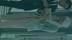 Animation of binary codes, illuminated pattern on keyboard, diverse couple discussing reports. Digital composite, multiple exposure, business, planning, teamwork and technology concept. - Powered by Shutterstock - Get 15% off with code: PIKWIZARD15