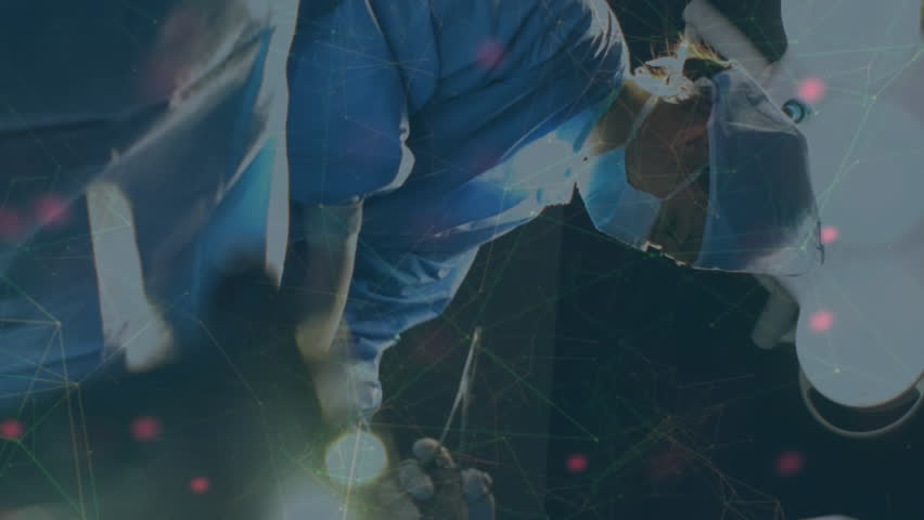 Animation of dna over diverse female and male surgeons during operation. medicine, health, science and technology concept during coronavirus covid 19 pandemic digitally generated video. - Powered by Shutterstock - Get 15% off with code: PIKWIZARD15