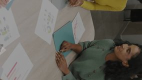 Animation of stock market data processing over diverse colleagues stacking their hands together. Global economy and business technology concept - Powered by Shutterstock - Get 15% off with code: PIKWIZARD15