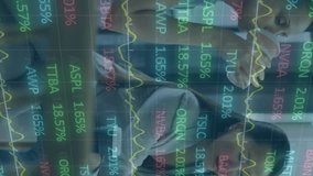 Animation of multicolored trading board over diverse female coworkers discussing reports on laptop. Digital composite, multiple exposure, teamwork, stock market and technology concept. - Powered by Shutterstock - Get 15% off with code: PIKWIZARD15