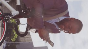 Animation of social media icons over african american businessman using smartphone on the street. Social media networking and business technology concept - Powered by Shutterstock - Get 15% off with code: PIKWIZARD15