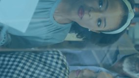 Animation of graphs, changing numbers, loading circles, bars, diverse coworkers discussing in office. Digital composite, multiple exposure, report, business, growth, progress and teamwork concept. - Powered by Shutterstock - Get 15% off with code: PIKWIZARD15