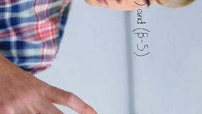 Animation of mathematical formulae over smiling schoolboy. education, childhood, creativity, communication and social media concept digitally generated video. - Powered by Shutterstock - Get 15% off with code: PIKWIZARD15