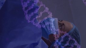 Animation of dna strands over diverse surgeons during operation. Technology, medicine and digital interface concept digitally generated video. - Powered by Shutterstock - Get 15% off with code: PIKWIZARD15