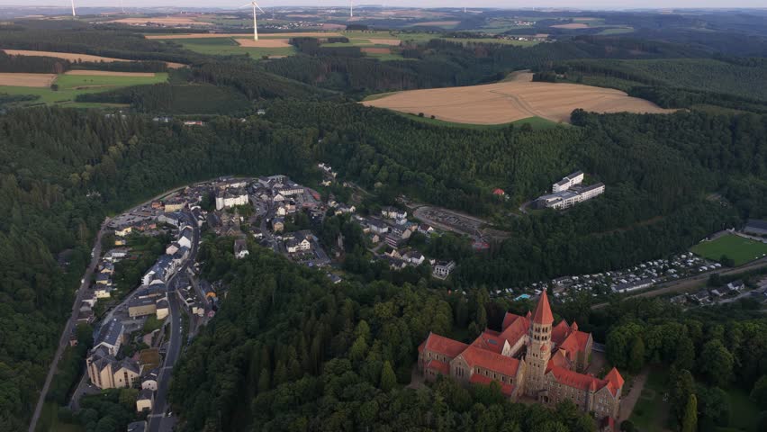 Clervaux, the Abbey of Saint Maurice and Saint Maur, plus the small mountain village setting in northern Luxembourg. Aerial view.