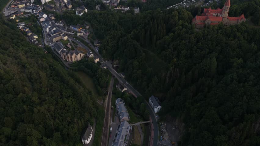 Clervaux, the Abbey of Saint Maurice and Saint Maur, plus the small mountain village setting in northern Luxembourg. Aerial view.