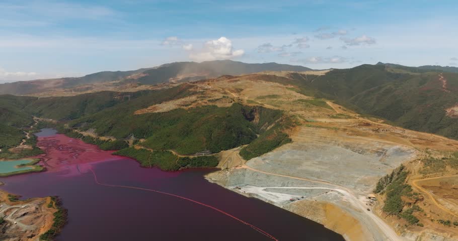Nickel mining aerial view with a burgundy color of lake. Mindanao, Philippines.