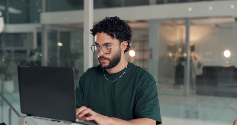 Man, thinking and laptop with typing at office, project management and content creation at media company. Person, computer and decision for editing process, review and feedback at creative agency