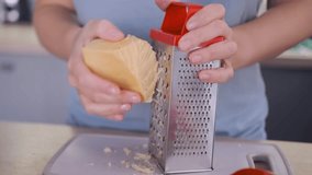 Woman hands grating cheese in a bright kitchen while preparing ingredients for a healthy homemade pizza. Cooking process, natural light, and healthy lifestyle. - Powered by Shutterstock - Get 15% off with code: PIKWIZARD15