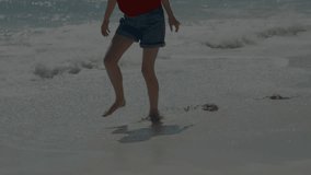 Woman stepping into ocean water, initiating turquoise light trails showing tech energy flow. Seashore, serenity, futuristic, digital, motion, energy, aquatic - Powered by Shutterstock - Get 15% off with code: PIKWIZARD15