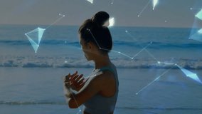 Woman performing shoulder stretch on beach activating network nodes spinning globe for fitness. Fitness, wellness, technology, digital, connectivity, health, outdoor - Powered by Shutterstock - Get 15% off with code: PIKWIZARD15