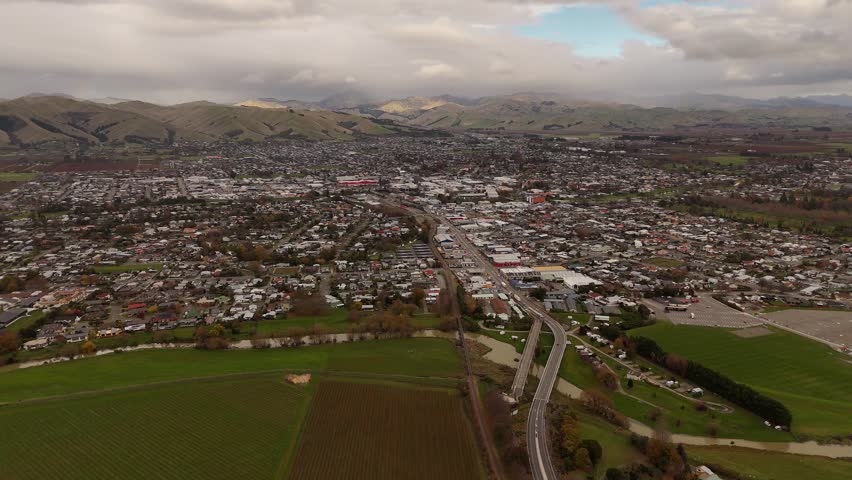 Blenheim cityscape and surrounding vineyards, town with hills in background, Marlborough, New Zealand. Aerial drone panoramic view