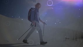 Male hiker pressing poles and striding across dune and revealing tech HUD graphics over landscape. Adventure, exploration, futurism, technology, outdoor, wilderness, innovation - Powered by Shutterstock - Get 15% off with code: PIKWIZARD15