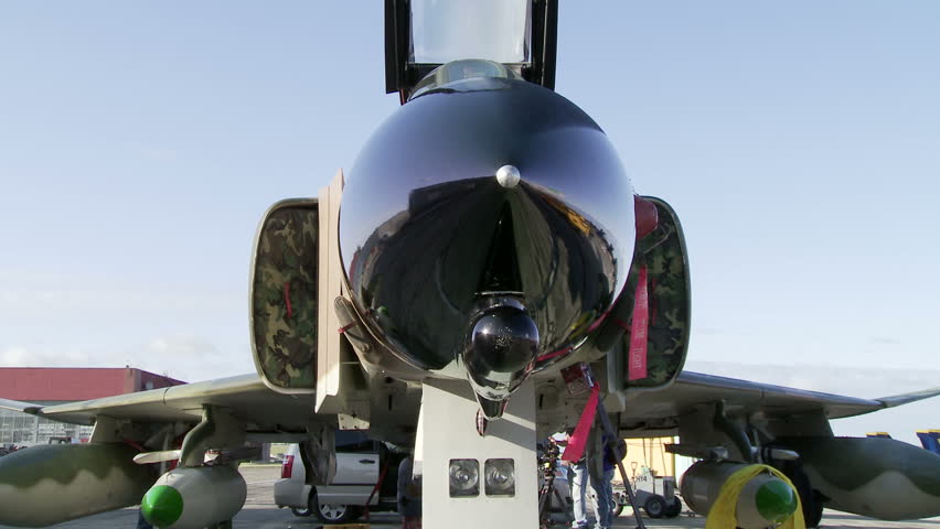 McDonnell Douglas F-4 Phantom jet fighter, parked on tarmac.  Dolly across