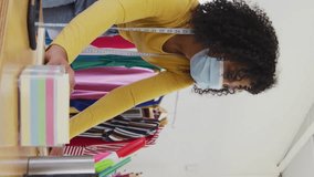 Animation of social media icons and numbers over african american woman with face mask using laptop. Global social media, connections and covid 19 pandemic concept digitally generated video. - Powered by Shutterstock - Get 15% off with code: PIKWIZARD15