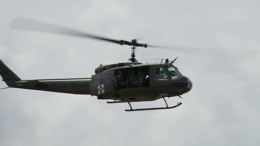Bell UH-1H Huey helicopter flying past the camera.  Slow motion recorded at