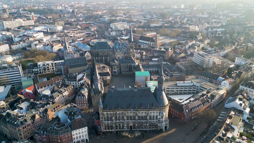 Aerial view of Aachen Rathaus, its dark tiled roof contrasting with the open market square and surrounding buildings, Aachen, North Rhine-Westphalia, Germany.