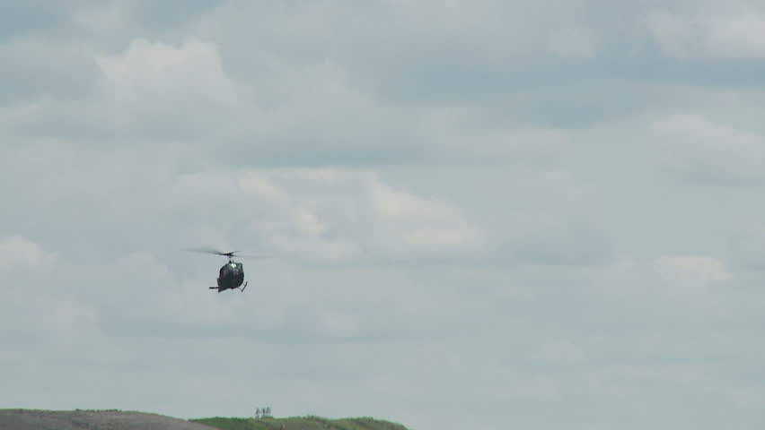 Bell UH-1H Huey helicopter flying towards a smoke marker.  Slow motion recorded