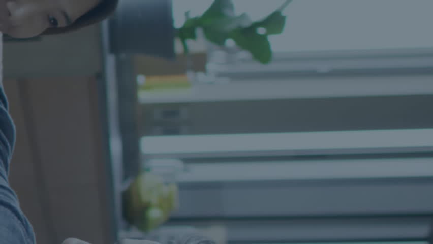 A happy couple spending quality time at home using a laptop. They are looking at social media and communication interfaces on the screen. Icons representing these platforms are seen in the video. - Powered by Shutterstock - Get 15% off with code: PIKWIZARD15