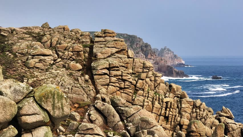 Rugged and scenic coastal cliffs of Cornwall on UK coastline, aerial tracking