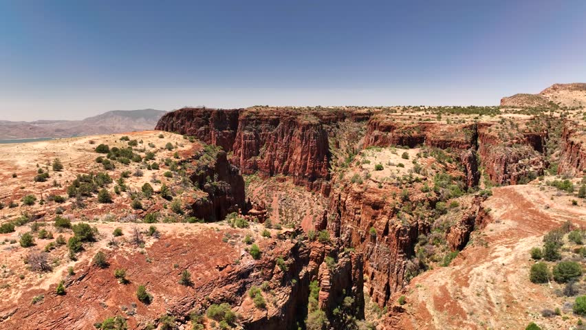 Aerial view of the red rock formations near the Upper Salt River and Armer Mountain, with sparse vegetation under a clear sky, Tonto Basin, AZ, USA.