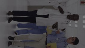 Animation of heart rate monitor over two diverse male doctors discussing in hospital corridor. Medical healthcare and research science technology concept - Powered by Shutterstock - Get 15% off with code: PIKWIZARD15