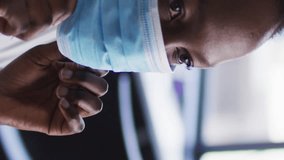 Animation of social media icons over african american woman adjusting her face masks at office. Social media networking and covid-19 pandemic concept - Powered by Shutterstock - Get 15% off with code: PIKWIZARD15