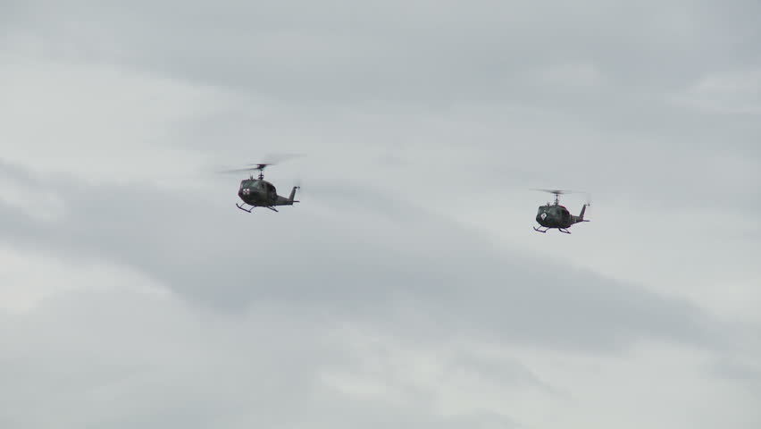 Bell UH-1H Huey helicopters flying in formation.
