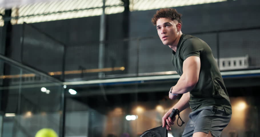 Training, court and man with padel tennis, match and competition with challenge. Fitness, athlete or person with practice, exercise or workout for tournament, sports or wellness with contest and game